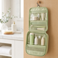 voyaglow hanging wash bag open on a bathroom door showing compartments