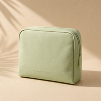 voyaglow sage green travel pouch on beige background
