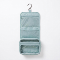 Hanging wash bag unfolded flat showing three tiers 4K