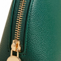 Macro detail of gold zipper and pebble-grain leather 4K
